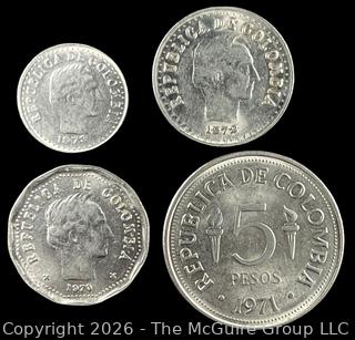 Four (4) Foreign coins in plastic holders, various dates and denominations. Columbia