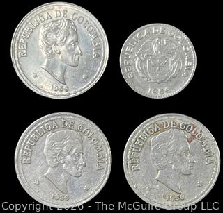 Four (4) Foreign coins in plastic holders, various dates and denominations. Columbia