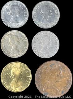 Six (6) Foreign coins in plastic holders, various dates and denominations. Great Britain
