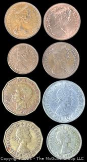 Eight (8) Foreign coins in plastic holders, various dates and denominations. Great Britain