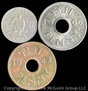 Three (3) Foreign coins in plastic holders, various dates and denominations. Fiji
