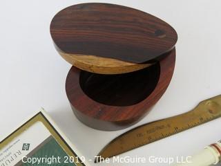 WYSIWYG: Desktop items: wood oval box, playing cards, letter opener, Harvard pen, Jaguar card case, pen