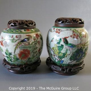 Two Oriental Ginger Jars w/ wood lids and wood bases (one damaged)