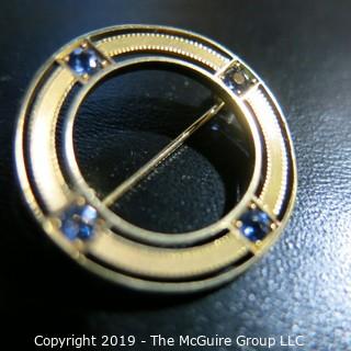 Jewelry: Circle pin, 14K yellow gold, 4 eye-clean bright blue sapphires measuring 1 1/16" diameter; 4.2 grams; (TMG 784) {Note: Description altered Nov. 20 @ 4:38pm ET}