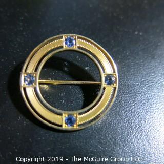 Jewelry: Circle pin, 14K yellow gold, 4 eye-clean bright blue sapphires measuring 1 1/16" diameter; 4.2 grams; (TMG 784) {Note: Description altered Nov. 20 @ 4:38pm ET}