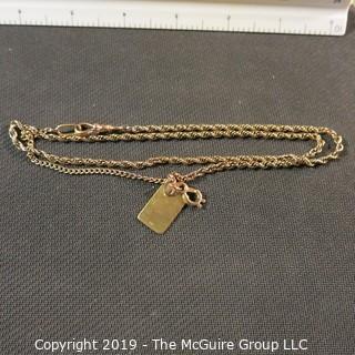 Jewelry:  Double rope 14K chain, 24", with bezel clasp with 3/4/ x1/2" in flat, charm. 16 grams (TMG 738)