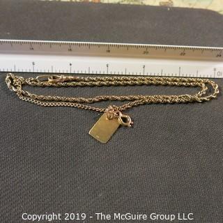 Jewelry:  Double rope 14K chain, 24", with bezel clasp with 3/4/ x1/2" in flat, charm. 16 grams (TMG 738)