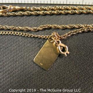 Jewelry:  Double rope 14K chain, 24", with bezel clasp with 3/4/ x1/2" in flat, charm. 16 grams (TMG 738)