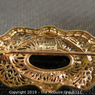 Jewelry:  Antique design, oval 14K yellow gold filigree with bezel set black onyx brooch, 32 x 18 mm.  Like new. 4.3 grams total weight; (TMG 756)