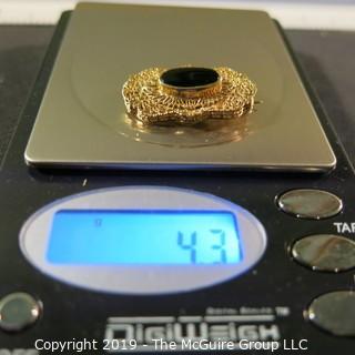 Jewelry:  Antique design, oval 14K yellow gold filigree with bezel set black onyx brooch, 32 x 18 mm.  Like new. 4.3 grams total weight; (TMG 756)