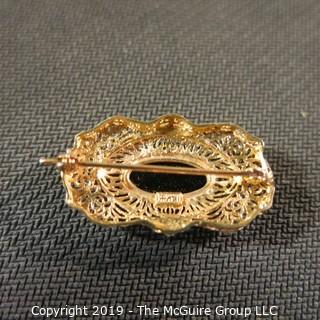 Jewelry:  Antique design, oval 14K yellow gold filigree with bezel set black onyx brooch, 32 x 18 mm.  Like new. 4.3 grams total weight; (TMG 756)