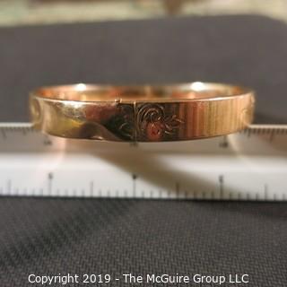 Jewelry: Vintage 10K Rose gold bangle with etched daisy, monogrammed, 65 x 57 mm, moderate wear; 13.1 grams. (TMG 745)