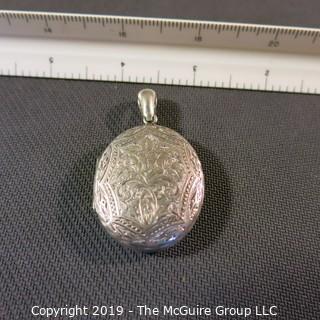 Jewelry:  Sterling oval engraved locket, 1.25 x 1.50 in. locket, lavishly engraved, leaves and an irises; faintly marked "Jessie from Charles; Aug 26, 1878" (photo #5); 11.1 grams (TMG 736) {Description Altered Nov. 18 at 1:16pm}