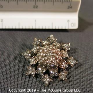 Jewelry: Antique 14K Rose gold and diamond, eight point star brooch.  Measures 34 mm, Approx. 2.50 ctw white rose-cut diamond’s (171), 7.9 grams. (TMG 753)