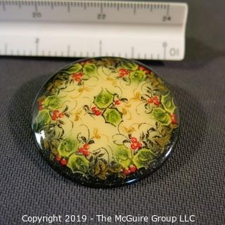 Jewelry: Russian Lacquer 2 in. round brooch (1998), Holly decoration in red, green antique white with black border. 