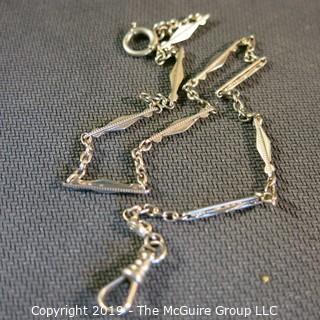 Jewelry: Cresent brand 14K white gold watch chain, with angular elongated diamond links, spring ring and bezel clasp, approx. 11 grams (TMG 739). 