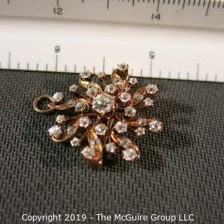 Jewelry: Rose gold (14K) Diamond Brooch with fold down locket bail, Floral motif, center diamond .50 ct and 1.45 ctw.  Diamonds are eye-clean, bright white (G color); 6.5 grams total weight (TMG 778)