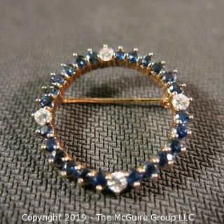 Jewelry: Two 14K Yellow gold diamond and sapphire circle pins.