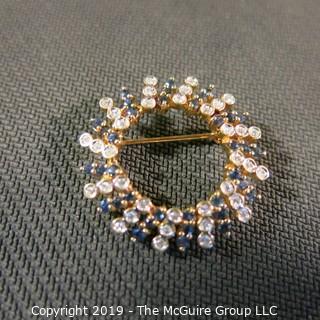 Jewelry: Two 14K Yellow gold diamond and sapphire circle pins.