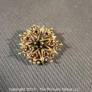 Jewelry: Vintage 14K garnet brooch, star inside an ornate circle, measuring 26.5 mm; 5.7 grams total weight; (TMG 774) 