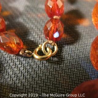 Jewelry: Necklace of 51 graduated and faceted Amber beads, 9 x 7 – 22 x 18mm, knotted – moderate wear.