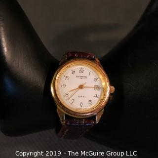 Jewelry: Ladies Wittnauer water resistant wristwatch, 1 in. round face, date, 7.5 in. brown leather band. 