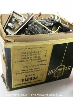 Collection of M-C Electronic Components including transformers, capacitors, air inductors, timers and switches