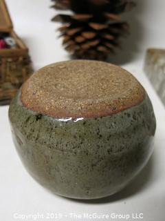 One very large pine cone; marble ash tray, box of buttons and signed ceramic pottery bowl