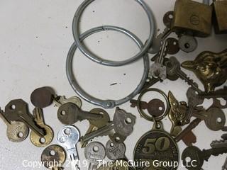 Collection including various types of keys, padlocks, and trinkets