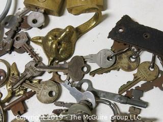 Collection including various types of keys, padlocks, and trinkets