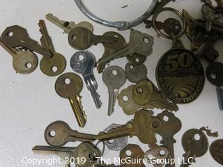 Collection including various types of keys, padlocks, and trinkets