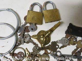 Collection including various types of keys, padlocks, and trinkets