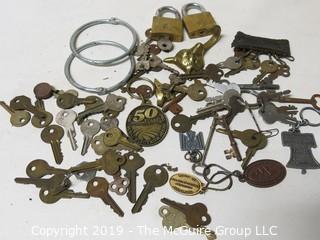 Collection including various types of keys, padlocks, and trinkets