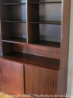 Danish Mid Century Modern (M-C-M) Bookcase with Lower Cabinet Featuring Sliding Doors.  NOTE: THE PHOTO SHOWS THREE (3) SECTIONS SIDE BY SIDE. THIS LOT CONSISTS OF THE LEFT SECTION ONLY.   THE MIDDLE AND RIGHT SECTIONS ARE BEING SOLD AS LOTS 0001 AND 0001B {Each section is 43" wide x 77"tall; lower cabinet is 17" deep, bookcase is 12" deep} 