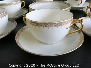 Set of 7 Limoges Porcelain Double Handle Cups and Saucers with 5 additional saucers made by D & C Delinieres & Co. White with Gilt Design. Made in France 