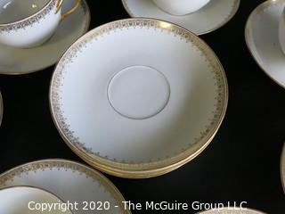 Set of 7 Limoges Porcelain Double Handle Cups and Saucers with 5 additional saucers made by D & C Delinieres & Co. White with Gilt Design. Made in France 