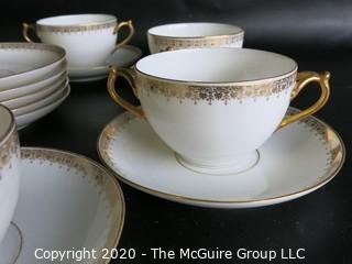 Set of 7 Limoges Porcelain Double Handle Cups and Saucers with 5 additional saucers made by D & C Delinieres & Co. White with Gilt Design. Made in France 