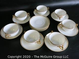 Set of 7 Limoges Porcelain Double Handle Cups and Saucers with 5 additional saucers made by D & C Delinieres & Co. White with Gilt Design. Made in France 