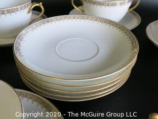 Set of 7 Limoges Porcelain Double Handle Cups and Saucers with 5 additional saucers made by D & C Delinieres & Co. White with Gilt Design. Made in France 