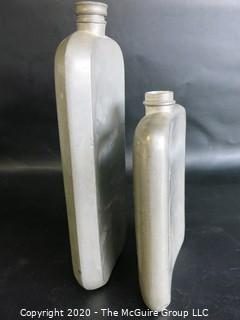 Two Metal Flasks.  Measures approximately 11" and 9" tall.  As is, one missing top.