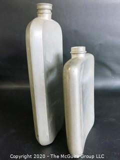 Two Metal Flasks.  Measures approximately 11" and 9" tall.  As is, one missing top.