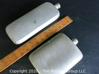 Two Metal Flasks.  Measures approximately 11" and 9" tall.  As is, one missing top.