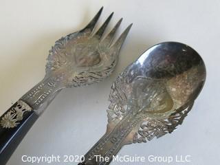 Pair of Silver Plate Serving Fork and Spoon, with Black Handles.  Made in Singapore.  Measures approximately 10" long