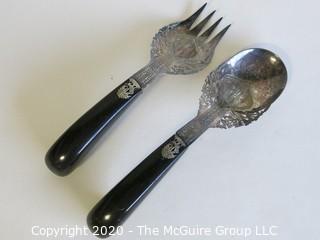 Pair of Silver Plate Serving Fork and Spoon, with Black Handles.  Made in Singapore.  Measures approximately 10" long