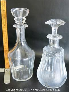 Two Clear Crystal Liquor Decanters. Measures Approximately 11" tall