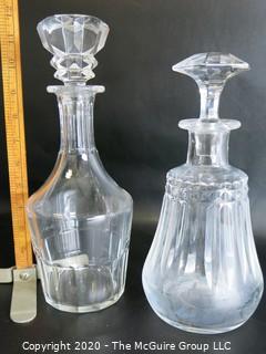 Two Clear Crystal Liquor Decanters. Measures Approximately 11" tall