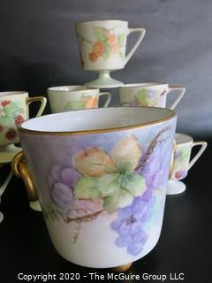 Set of 8 Floral Patterned Porcelain Footed Cups and Urn.  Hand Painted and signed by Artist. 