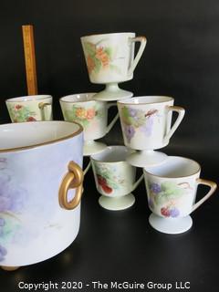 Set of 8 Floral Patterned Porcelain Footed Cups and Urn.  Hand Painted and signed by Artist. 