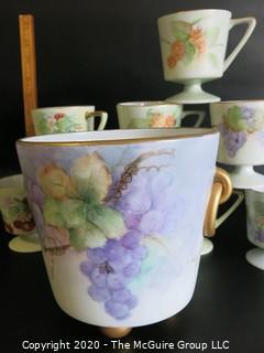 Set of 8 Floral Patterned Porcelain Footed Cups and Urn.  Hand Painted and signed by Artist. 