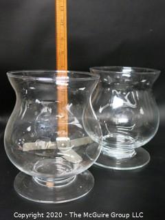 Two Clear Glass Footed Hurricane Candle Holders. 